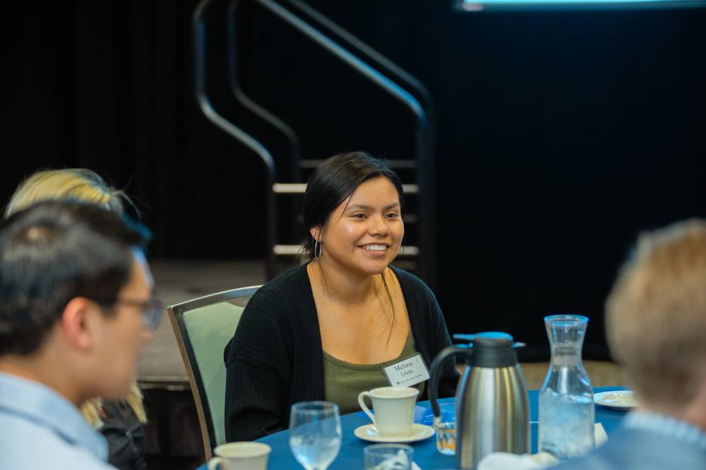 Student smiling at a table at Scholarship Dinner 2019